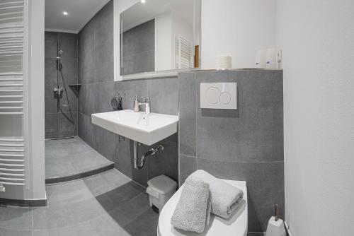 a bathroom with a sink and a toilet and a shower at Chalet La Belle Willingen in Willingen