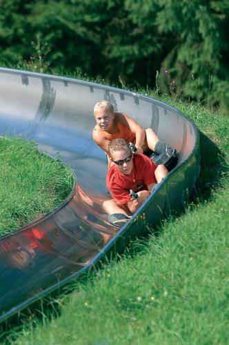 a man and a child are riding in a raft in a river at Chalet La Belle Willingen in Willingen