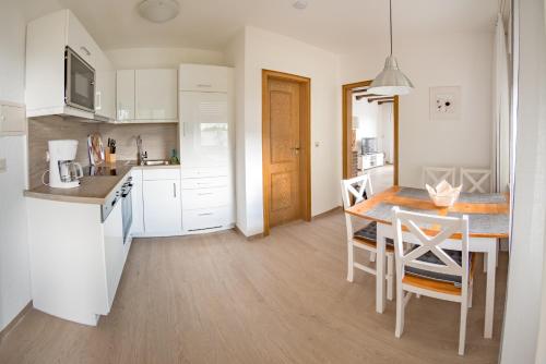 a kitchen with a table and chairs in a kitchen at Chalet La Belle Willingen in Willingen