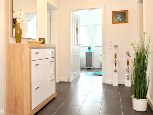 a kitchen with a counter and a tile floor at Ferienwohnung Bock Feldmannshof in Drolshagen