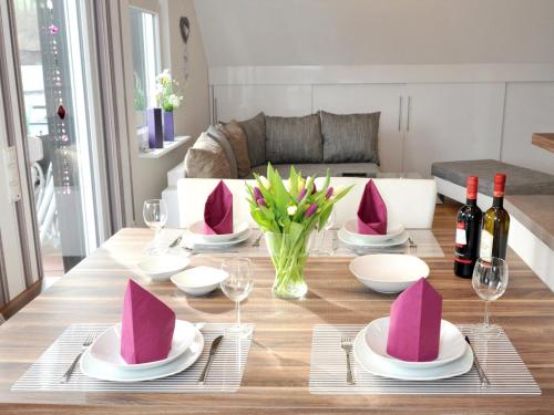 a dining room table with pink hats on it at Ferienwohnung Bock Feldmannshof in Drolshagen