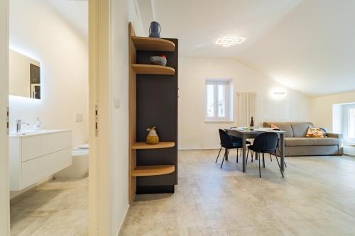 a kitchen and living room with a table and chairs at Il Nido di Cuneo in Cuneo
