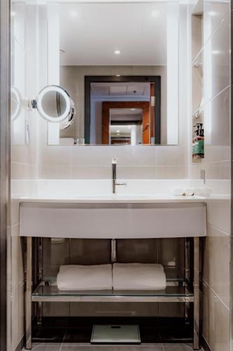 a bathroom with a sink and a mirror at Hyatt Regency London Albert Embankment in London