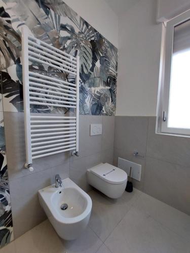 a white bathroom with a sink and a toilet at Dimora Gentile Lecce B&B in Lecce