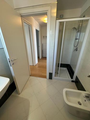 a bathroom with a shower and a sink at Sky Residence in Lignano Sabbiadoro