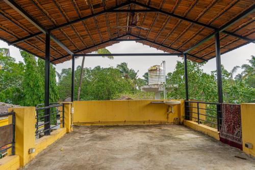 an empty building with a yellow wall and a sink at 2BHK at Portuguese villa by Goaround Homes in Anjuna