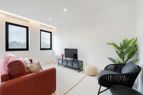 a living room with a couch and a tv at GuestReady - Good times in Matosinhos in Matosinhos