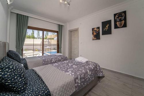 A bed or beds in a room at Portakal Çiçeği 1