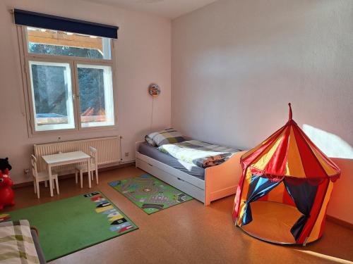 a room with a bed and a tent in it at Familienfreundliche Ferienwohnung in Benneckenstein