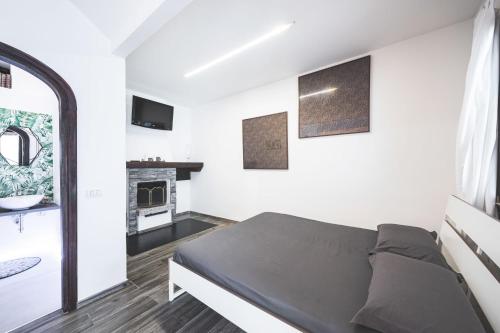 a bedroom with a bed and a fireplace at Luce del lago in Moltrasio
