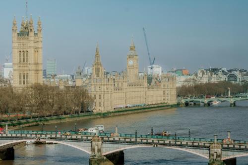 a bridge over a river in front of a large building at Hyatt Regency London Albert Embankment in London