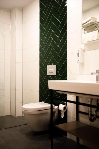a bathroom with a toilet and a sink at Polek Hotel in Canakkale