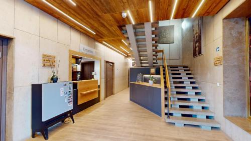 a hallway with a staircase in a building at Hotel am Stadtpark Nordhausen in Nordhausen