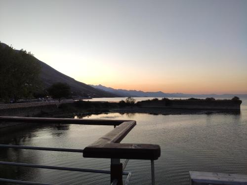 a view of a river with the sunset in the background at Sunny Side Apartment Shkoder Albania in Shkodër