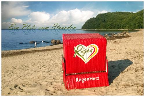 a red drink box sitting on the beach at RügenHerz DACHTRÄUME Atelierwohnung 1 - 4 Personen in Parchtitz