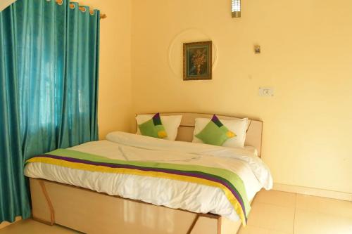 a bedroom with a bed with a blue curtain at The Hidden Cove in Bhīm Tāl
