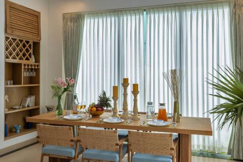 a dining room table with chairs and a large window at 4BR w Pvt Pool nr Coco Beach, Nerul in Nerul
