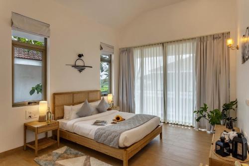 a bedroom with a large bed and a large window at 4BR w Pvt Pool nr Coco Beach, Nerul in Nerul