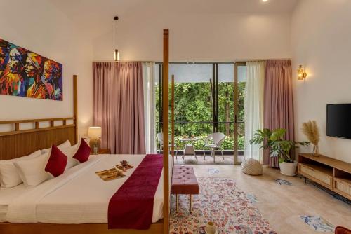 a bedroom with a large bed and a large window at 4BR w Pvt Pool nr Coco Beach, Nerul in Nerul