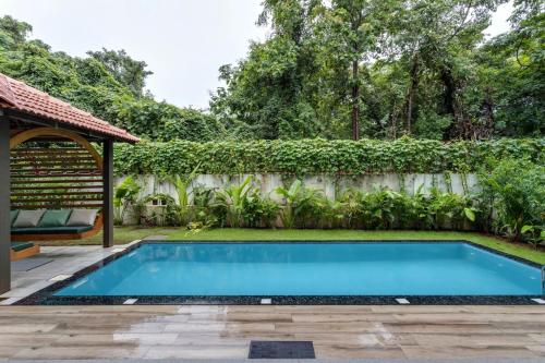 a swimming pool in a backyard with a fence at 4BR w Pvt Pool nr Coco Beach, Nerul in Nerul