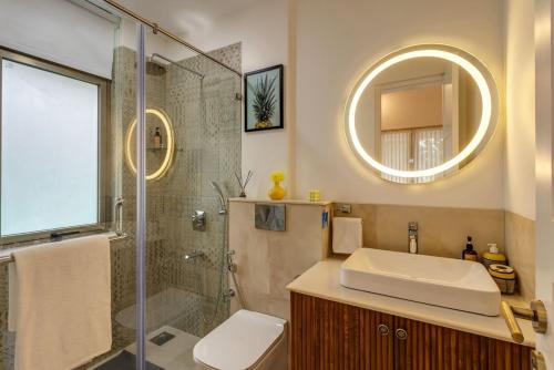 a bathroom with a shower and a sink and a mirror at 4BR w Pvt Pool nr Coco Beach, Nerul in Nerul