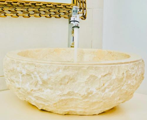 a marble sink with a faucet on a counter at Canaryislandshost l Boya Suites in Playa Honda