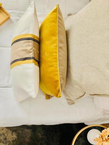 two pillows sitting on top of a couch at Canaryislandshost l Boya Suites in Playa Honda