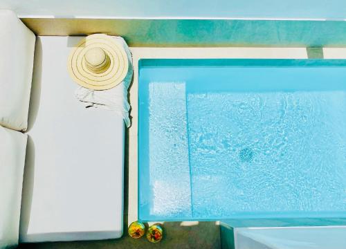 a straw hat sitting next to a window on a boat at Canaryislandshost l Boya Suites in Playa Honda