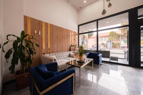 a living room with a couch and a table at Polek Hotel in Canakkale