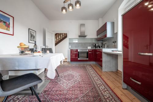 a kitchen with a white table and red cabinets at Domitian 2 in Millstatt