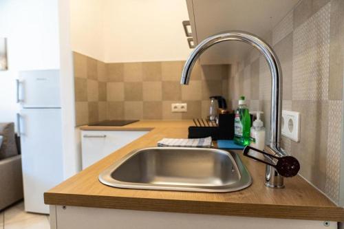 a kitchen counter with a sink in a kitchen at Flow Apartments WOLKENSTEIN in Merano