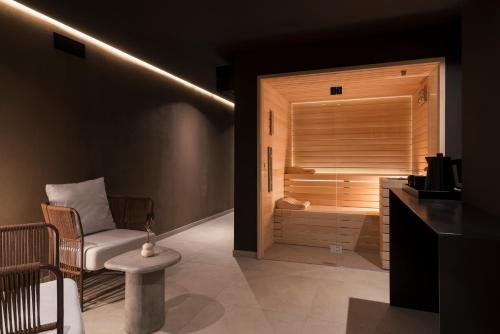 a room with a sauna with a bench and a chair at Stemor Visionary Apartments in Desenzano del Garda