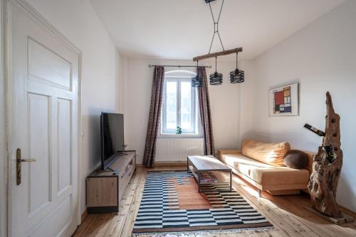 a living room with a couch and a tv at Domitian 2 in Millstatt