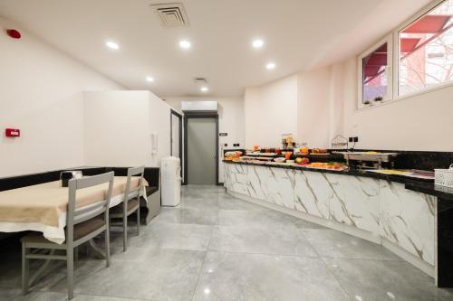 a dining room with a table and a counter at Polek Hotel in Canakkale