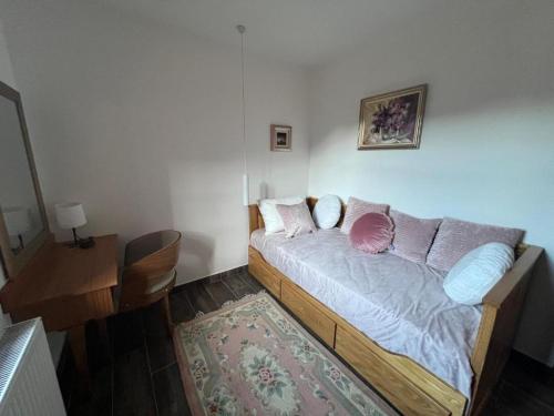 a bedroom with a bed with pillows and a rug at Serbina in Kandalica