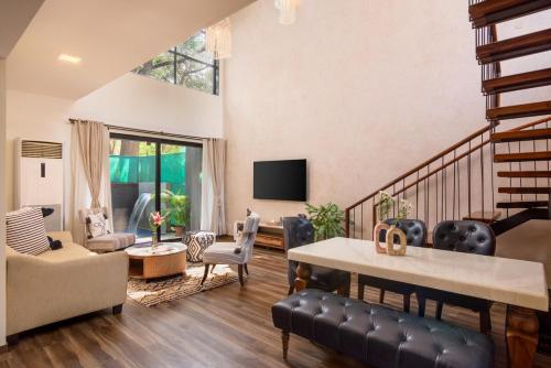 a living room with a couch and a table at Nistula Luxury Pool Villa C3 in Assagao in Assagao