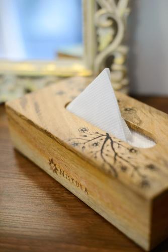a wooden box with a piece of paper on a table at Nistula Luxury Pool Villa C3 in Assagao in Assagao