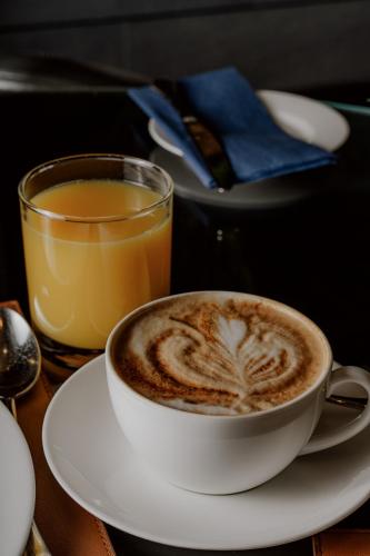 a cup of coffee and a glass of orange juice at Hyatt Regency London Albert Embankment in London