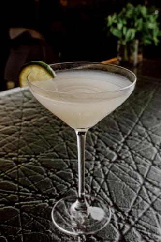 a martini glass with a lime on a table at Hyatt Regency London Albert Embankment in London