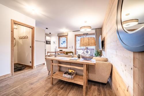 a living room with a table and a couch at Apartment Altum, Morzine - by EMERALD STAY in Morzine