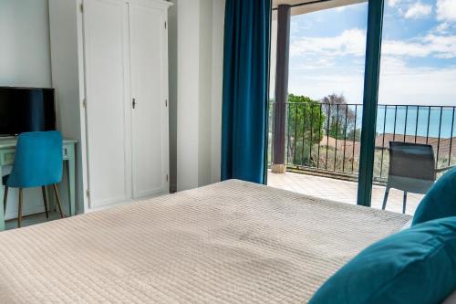 a bedroom with a bed and a view of the ocean at AHG Riva Del Sole Hotel - Adults Only in Moniga