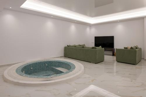 a living room with a large pool in the middle of the room at Villa Sunset, stunning villa rental in Corfu by PosarelliVillas in Perítheia