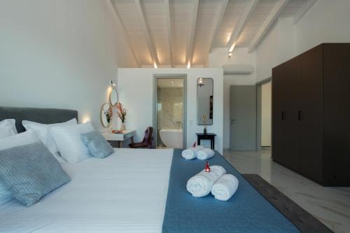 a bedroom with a bed with towels on it at Villa Sunset, stunning villa rental in Corfu by PosarelliVillas in Perítheia