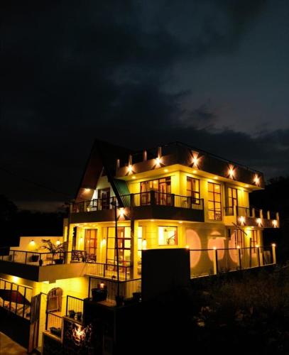 a large building with lights on it at night at Affinity Villa Dikoya in Dikoya