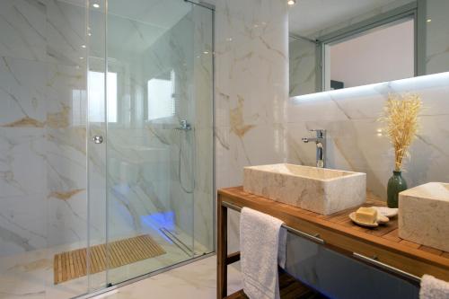a bathroom with a sink and a shower at Villa Sunset, stunning villa rental in Corfu by PosarelliVillas in Perítheia