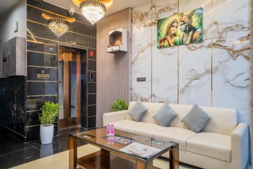 a living room with a couch and a table at Hotel De Grand Dwarka-Near Jaipur Airport in Jaipur
