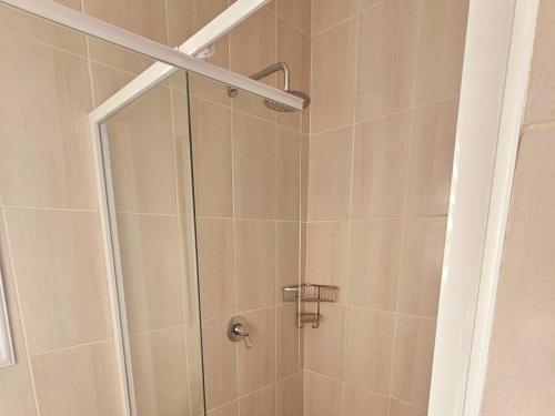 a shower with a glass door in a bathroom at Tranquility Inn in Welkom