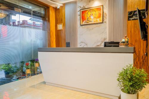 a white counter in a room with a window at Hotel De Grand Dwarka-Near Jaipur Airport in Jaipur