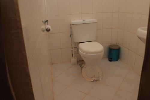 a dirty bathroom with a toilet in a stall at ELANGATA OLERAI LUXURY TENTED CAMP in Narok
