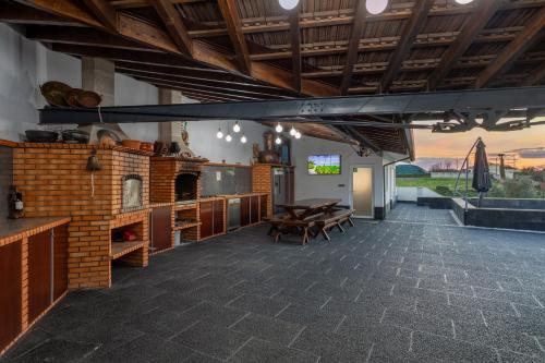 a living room with a table and a brick fireplace at Bandeira'S house in Antuã
